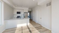 Located at 192 Erie St in Port Colborne, Ontario, this thoughtfully designed 2-bedroom, 1-bathroom unit offers a clean, modern aesthetic across a single floor. The open-concept kitchen and living area serves as the heart of the home, featuring white shaker-style cabinetry, stainless steel appliances including a refrigerator, stove, and microwave, a central island with an undermount sink, and recessed pot lighting. Light wood-tone laminate flooring runs throughout the main living areas, enhancing the bright and airy feel of the space. Both bedrooms are carpeted in a neutral tone and each includes a sliding-door closet for ample storage. The primary bedroom offers a large window with views of the surrounding neighbourhood, filling the room with natural light. The second bedroom also features a built-in closet. The bathroom is well-appointed with a full soaker tub and shower combo, featuring striking marble-style wall surrounds, a vanity with a stone countertop, and matching wood-tone flooring. The hallway connects all rooms efficiently, maintaining a clean, uncluttered flow throughout. With its fresh, contemporary finishes and functional layout, this unit presents a polished and move-in-ready living space.
