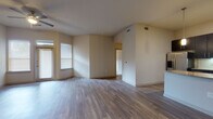 Located at 2223 Waterloo City Ln in Austin, Texas, this single-floor residence offers a thoughtfully designed open-concept layout with modern finishes throughout. The spacious living area features warm wood-look flooring, neutral walls, and multiple windows fitted with blinds that allow generous natural light to fill the space. Ceiling fans are present in key living and sleeping areas for added comfort.

The kitchen is a standout feature, showcasing dark espresso cabinetry, granite countertops, a white subway tile backsplash, and a full suite of stainless steel appliances including a refrigerator, range, and microwave. A central island with pendant lighting provides additional prep space and a natural gathering point that flows seamlessly into the living area.

The bedrooms are carpeted for comfort, each offering natural light through windows and ceiling fans. The primary bedroom includes direct access to a walk-in closet and an en-suite bathroom. The bathrooms feature marble-look tile flooring and dark vanity cabinetry with white countertops. One bathroom offers a tub-shower combination with white tile surround, while another provides a spacious vanity with a wide mirror. The overall design balances practicality with contemporary style throughout.