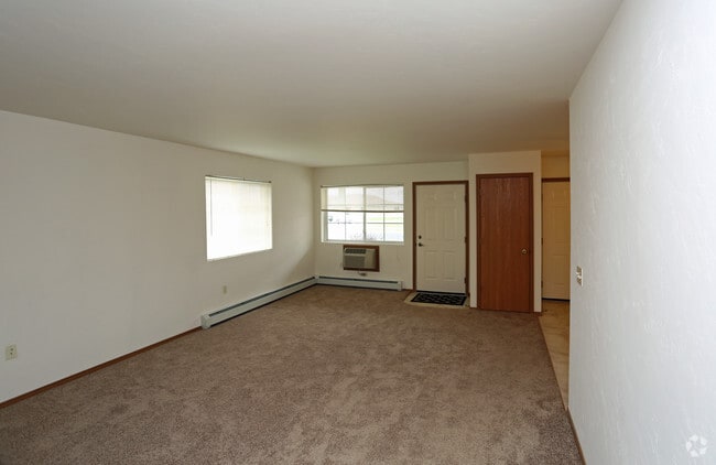 End unit Living room with carpet - East Ridge Estates