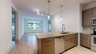 This contemporary 980 square foot apartment in Philadelphia offers a blend of style and functionality. The open-concept design seamlessly integrates the kitchen and living areas, creating a spacious feel. The gourmet kitchen is equipped with sleek, wood-grain cabinetry, granite countertops, and stainless steel appliances, including a built-in microwave and electric range.

The two bedrooms are generously sized, with the primary bedroom boasting 140 square feet of space. Large windows in the bedrooms and living areas flood the apartment with natural light and offer city views. Plush carpeting in the bedrooms contrasts with the gleaming hardwood floors in the main living spaces.

The apartment features three well-appointed bathrooms, including an en-suite in the primary bedroom. The bathrooms showcase modern fixtures, ample storage, and a mix of tiled and carpeted flooring. Two closets provide additional storage space.

The unit's thoughtful layout includes a hallway connecting the various rooms, enhancing privacy and flow. The neutral color palette throughout creates a canvas for personal style. This apartment combines urban sophistication with practical living, perfect for those seeking a contemporary home in the heart of Philadelphia.