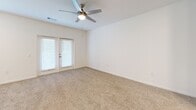 Located at 597 Wildlight Ave in Yulee, Florida, this well-appointed 2-bedroom, 1-bathroom residence offers a thoughtfully designed single-floor layout. The kitchen is a standout feature, showcasing crisp white shaker cabinetry, granite countertops, a subway tile backsplash, and a full suite of stainless steel appliances including a range, microwave, and dishwasher. A central island with pendant lighting adds both counter space and a casual dining option, while light wood-look flooring completes the clean, contemporary aesthetic.

Both bedrooms feature plush carpeting, ceiling fans with light fixtures, and natural light from well-placed windows. Each bedroom includes access to a dedicated closet, with the primary bedroom offering a generous walk-in closet. The second bedroom features French doors, adding an elegant touch. The bathroom is finished with a dual-sink granite vanity, white cabinetry, a large mirror, and wood-look flooring, maintaining the cohesive design language found throughout the home.

A connecting hallway links the living areas efficiently. The overall palette of bright whites and neutral tones creates a light, airy ambiance throughout this move-in-ready Yulee residence.