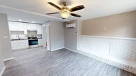 Located at 805 E Red Bud Rd in Knoxville, TN, this efficiently designed single-story home offers three bedrooms and two bathrooms across a thoughtfully laid-out floor plan. The open-concept living room and kitchen area serves as the heart of the home, featuring light gray luxury vinyl plank flooring, a ceiling fan, a wall-mounted mini-split HVAC unit, and a distinctive white brick accent wall that adds character and charm to the space.

The kitchen is a standout feature, boasting white shaker cabinetry extending to the ceiling for maximum storage, dark granite countertops, a subway tile backsplash, and a full suite of stainless steel appliances including a refrigerator, electric range, and dishwasher.

The bedrooms are finished with durable vinyl plank flooring, ceiling fans, and natural light from windows with views of surrounding greenery. Each bedroom includes closet space with wire shelving systems for organized storage.

The bathrooms are clean and modern, with one featuring a white subway-tiled tub surround with a natural light window, and the other offering a grey vanity with a white integrated sink and a wood-framed mirror. A dedicated utility room rounds out the functional layout of this move-in-ready Knoxville home.