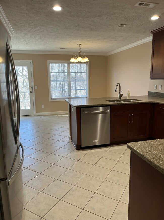 View from kitchen into eating area with patio outside - 2233 Whitney Ct