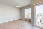Located at 14935 W Van Buren St in Goodyear, AZ, this two-story home offers 3 bedrooms and 4 bathrooms across two thoughtfully designed floors. The ground floor houses an attached garage with automatic opener, water heater, and direct interior access, alongside an open-concept kitchen featuring a central island with sink, white shaker cabinetry, stainless steel appliances, recessed lighting, and light wood-look flooring that flows throughout the main living areas. A sliding glass door and large windows bring in abundant natural light. The upper floor contains all three bedrooms, each equipped with ceiling fans and plush carpeting. The primary bedroom is a generous retreat with a walk-in closet and an en-suite bathroom showcasing a tiled shower, wood-look flooring, and a vanity with modern hardware. Additional bedrooms are well-proportioned with bright windows, and the upper hallway connects all rooms via a carpeted staircase. The four bathrooms are finished with neutral tones and clean, contemporary fixtures. Consistent warm-gray walls, white trim, and wood-look flooring throughout create a cohesive, modern aesthetic suited to the sunny Goodyear climate.