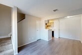Located at 11500 Green Plaza Dr in Houston, TX, this two-story, one-bedroom, one-bathroom residence offers a thoughtfully organized layout spread across two floors. The main level welcomes you through a dedicated entrance into an open living and dining area, finished with durable wood-style plank flooring and neutral-toned walls throughout. A sliding glass door in the living room fills the space with natural light and provides direct outdoor access. The galley-style kitchen is well-equipped with gray cabinetry, a classic white subway tile backsplash, marble-look countertops, black appliances including a range and refrigerator, and a dishwasher. A pantry provides additional storage, and a pass-through opening connects the kitchen to the living area. A staircase leads to the upper floor, where the private bedroom awaits, carpeted for comfort and featuring a window with outdoor views. Two closets offer ample storage on this level. The full bathroom includes a tiled tub-shower combination and wood-style flooring. Textured ceilings are consistent throughout the home, and central HVAC ensures year-round comfort. This efficient, multi-level layout is well-suited for those seeking a practical and comfortable living space in north Houston.