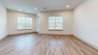 Located at 9001 Metcalf Ave in Overland Park, KS, this single-floor residence offers two bedrooms and two bathrooms within a thoughtfully designed, modern layout. The open-concept living and kitchen area serves as the heart of the unit, featuring light wood-look flooring, recessed lighting, and large windows that invite abundant natural light. The kitchen is outfitted with dark espresso cabinetry, stainless steel appliances, a white quartz island with an undermount sink, white tile backsplash, and pendant lighting overhead.

The living area extends toward a glass door providing outdoor access, with additional windows framing views of the surrounding area. The primary bedroom includes plush carpeting, a ceiling fan, direct access to an en-suite bathroom, and a dedicated walk-in closet with multi-level shelving and hanging rods. The secondary bedroom also features carpeting and a window with exterior views.

Both bathrooms are finished with wood-look flooring, while one includes a tub-shower combination adorned with large-format marble-style tile and dark matte hardware accents. The dedicated laundry room houses a full-size washer and dryer beneath overhead shelving.
