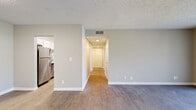 Located at 502 Blackpatch Dr in Springfield, TN, this 2-bedroom, 1-bathroom unit offers a well-designed single-floor layout with a thoughtful blend of comfort and modern finishes. The open living room is a highlight, featuring durable wood-look flooring, neutral-toned walls, a textured ceiling, and a large sliding glass door that floods the space with natural light and provides outdoor views. The kitchen is well-appointed with crisp white cabinetry extending to the ceiling, marble-look countertops, a stainless steel sink, and stainless steel appliances including a dishwasher and range. Both bedrooms are carpeted and share a warm, neutral palette, with each room offering windows that bring in natural light. The primary bedroom is generously sized, providing ample space for furnishings. The bathroom features a white tiled tub-shower combo, a marble-look vanity countertop with white cabinetry, and wood-look flooring with brushed gold hardware accents. A dedicated closet adds practical storage. Consistent use of neutral tones, clean lines, and modern fixture choices throughout the unit creates a cohesive and move-in-ready living environment.
