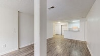 Located at 3529 Robins Landing Way in Decatur, GA, this single-story home offers four bedrooms, two bathrooms, and a practical, well-organized layout. Consistent wood-look flooring runs throughout the entire home, providing a cohesive and easy-to-maintain finish. Textured ceilings and crisp white walls create a clean, neutral backdrop across all rooms.

The open living area connects seamlessly to the kitchen, which features a galley-style design with white cabinetry, laminate countertops, a coil-burner electric range, a refrigerator, a dishwasher, and an in-unit washer. A pass-through counter opens the kitchen to the living space, enhancing the sense of openness.

The four bedrooms are bright and practical, with several rooms featuring windows that bring in natural light. Each bedroom benefits from dedicated closet space, with four closets total throughout the home. The primary bedroom offers a comfortable and functional footprint.

The two bathrooms are finished in a consistent style, each featuring a tub-shower combination, wood-look flooring, and white fixtures. One bathroom includes a wall-mounted sink and accessibility grab bars, while the other offers a more traditional vanity setup with overhead lighting and a mirror.

Overall, the home presents a clean, move-in-ready interior with a straightforward and functional design throughout.