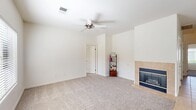 Located at 9701 Sherborne Ave in Bakersfield, California, this single-story 2-bedroom, 2-bathroom home offers a well-designed layout that maximizes its comfortable footprint. The open-concept living, dining, and kitchen area serves as the heart of the home, featuring plush carpeting and a tile-surround fireplace with a classic glass screen in the living room, complemented by a ceiling fan overhead. The kitchen is outfitted with white cabinetry, granite countertops, stainless steel appliances, and a peninsula that doubles as a breakfast bar — ideal for casual dining. A dedicated pantry provides additional storage convenience. Both bedrooms are carpeted and equipped with ceiling fans, with the spacious primary bedroom featuring dual closets and natural light from a window with blinds. The bathrooms are finished with granite-topped vanities, white cabinetry, and tile flooring, with one bathroom including a tub-shower combo with sliding glass doors. A hallway connects the main living spaces, with multiple closets offering ample storage throughout. The attached garage features an automatic opener and a concrete floor, providing secure parking and additional utility space.