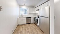 Located at 43 W 100 S in North Salt Lake, Utah, this 2-bedroom, 2-bathroom single-floor unit offers a clean, modern layout designed for comfortable everyday living. The living room features wood-look plank flooring and a sliding glass door that fills the space with natural light and provides access to the outdoors. The kitchen is well-appointed with crisp white shaker cabinetry, light countertops, a stainless steel dishwasher, range, and refrigerator, along with a window above the sink that brings in additional natural light. Both bathrooms are neatly finished, with one featuring a single vanity with a marble-style countertop, white cabinetry, and a tub-shower combination. The two bedrooms are carpeted for warmth and comfort, each with windows fitted with blinds. The primary bedroom offers a notably generous footprint and direct access to a bathroom. Throughout the unit, four closets provide substantial storage space, including a walk-in closet with dual hanging rods. Neutral gray-toned walls and consistent finishes create a cohesive, move-in-ready aesthetic throughout the home.