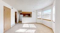 Located at 991 S Crystal Way in Aurora, Colorado, this one-bedroom, one-bathroom residence offers a well-organized layout across a single floor. The open-concept living and kitchen area forms the heart of the home, bathed in natural light from multiple windows. The living room features soft carpeting, neutral walls, a textured ceiling, and sliding glass doors that open to a private balcony overlooking the surrounding neighborhood and mature trees. The kitchen is equipped with warm wood cabinetry, granite-look countertops, a double stainless steel sink, a full-size refrigerator, and an electric range, all complemented by tile flooring. A pendant light fixture above the kitchen pass-through adds a charming detail to the shared space. An in-unit laundry area is conveniently accessible directly from the kitchen. The bedroom offers comfortable carpeting, a dedicated closet, and a window that brings in natural light. Five closets throughout the unit provide generous storage. The bathroom includes a tiled tub-and-shower combination, a vanity with matching granite-look countertops, wood cabinetry, and a large mirror. The overall ambiance is clean, bright, and functional, making this a practical and comfortable Aurora residence.