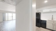 Located at 373 NW 5th St in Oklahoma City, this 3-bedroom, 3-bathroom unit offers a well-designed single-floor layout that maximizes its footprint efficiently. The open-concept living, dining, and kitchen area serves as the heart of the home, featuring light luxury vinyl plank flooring, neutral-toned walls, and a textured ceiling. Sliding glass doors in the living room lead to a patio and invite abundant natural light into the space.

The kitchen is thoughtfully appointed with white shaker-style cabinetry, white subway tile backsplash, light quartz countertops, and a full suite of black and stainless steel appliances, including a refrigerator, electric range, and dishwasher. A deep stainless steel sink with a modern pull-down faucet completes the functional workspace.

The bedrooms are carpeted and include large windows offering expansive city views of the Oklahoma City skyline and surrounding neighborhoods. The primary bedroom features a wide sliding-door closet for generous storage. The bathrooms are finished in a clean, contemporary style with gray vanity cabinetry, white quartz countertops, and white subway-tiled tub-shower surrounds. Additional closets and pantry spaces provide ample storage throughout the unit.
