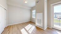 This efficiently designed unit in Richland, Washington, offers a thoughtfully organized single-floor layout that maximizes every square foot. The open-concept main area seamlessly integrates the living room, dining space, and kitchen, creating a cohesive and functional environment. Light wood-style flooring runs throughout, complementing the bright, neutral color palette that enhances the sense of openness.

The kitchen is well-appointed with dark wood-tone cabinetry extending to the upper walls, stainless steel appliances including a refrigerator and dishwasher, a double-basin sink, and ample counter space — offering both practicality and a modern aesthetic. Natural light flows in generously through the windows and a glass-paneled entry door, keeping the living area bright and welcoming.

The full bathroom features a clean, contemporary design with a dark wood vanity, white countertop, and accessible grab bars throughout, reflecting a thoughtful, inclusive design approach. Light wood flooring continues here, tying the space together cohesively.

Two closets provide convenient storage solutions within the unit. A private balcony extends the living space outdoors, offering a personal outdoor retreat. Overall, the unit presents a clean, modern aesthetic well-suited for comfortable everyday living in Richland, WA.