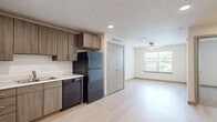 Located at 4025 Salisbury Rd in Jacksonville, FL, this one-bedroom, one-bathroom residence offers a thoughtfully designed single-floor layout that maximizes every square foot. The open-concept main area seamlessly combines the kitchen, dining, and living spaces, all finished with light wood-tone flooring that enhances the bright, airy feel throughout. Natural light flows in through a window in the living area, complemented by a ceiling fan overhead.

The kitchen is well-equipped with warm wood-toned cabinetry extending from floor to ceiling, light countertops, and a full suite of black appliances including a refrigerator, dishwasher, electric range, and over-the-range microwave. A stainless sink with clean white backsplash completes the functional cooking space.

The bedroom features plush carpet flooring, a ceiling fan, a window with natural light, and access to a spacious walk-in closet outfitted with wire shelving systems for ample storage. The bathroom offers a tub/shower combination, a wide vanity with light countertops and wood cabinetry, and a large mirror with overhead lighting. Additional conveniences include a dedicated laundry area and recessed lighting throughout the common spaces, all accented by a neutral color palette that creates a clean, move-in-ready environment.