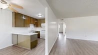 Located at 3070 W Del Monte Dr in Anaheim, CA, this single-story, 2-bedroom, 1-bathroom home offers a practical and well-organized layout. Light wood-style flooring flows consistently throughout the home, creating a cohesive and clean aesthetic.

The living room is a bright, open space featuring a textured ceiling, a wall-mounted HVAC unit, and a window that allows natural light to filter in. It connects seamlessly to the kitchen area, reinforcing the open-concept feel of the home.

The kitchen is well-equipped with warm-toned wood cabinetry, white appliances including a gas range and built-in microwave, a stainless steel sink, and a white quartz peninsula countertop that provides additional prep and storage space.

The two bedrooms are carpeted with light-toned wood-style flooring and feature clean white walls. The primary bedroom is generously sized, while the second bedroom offers a bright window with natural light. A dedicated walk-in closet with built-in hanging rods provides ample storage.

The bathroom features a long white quartz vanity countertop with dual mirrors, white cabinetry, and a textured ceiling. A connecting hallway links the bathroom and bedrooms efficiently. The home's clean, neutral palette throughout makes it move-in ready.