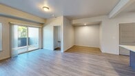 Located in Spokane Valley, WA, this well-appointed 2-bedroom, 3-bathroom unit offers a comfortable and functional single-floor layout. The open-concept living area features light wood-style luxury vinyl flooring, neutral walls, and a wall-mounted mini-split AC unit, creating a bright and airy atmosphere. Large windows allow natural light to fill the space, with a sliding glass door providing access to an outdoor balcony area.

The kitchen is a standout feature, boasting rich, dark-toned cabinetry, crisp white quartz countertops, and a full suite of stainless steel appliances including a refrigerator, electric range, microwave, and dishwasher. A peninsula with an undermount sink and stylish pendant lighting adds both functionality and character to the space.

Both bedrooms are finished with plush, neutral carpeting and feature generously sized sliding panel closets, providing ample storage. The primary bedroom offers a comfortable footprint with a bright window view. The bathrooms are cleanly designed, with one featuring a full soaking tub and shower combination alongside wood-style tile flooring and dark cabinetry vanities. The overall aesthetic is modern, clean, and move-in ready.