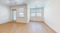 Located at 8775 Clay St in Westminster, CO, this thoughtfully designed two-bedroom, one-bathroom unit offers a clean, modern aesthetic across a single floor. Light wood-tone flooring runs consistently throughout the space, lending warmth and visual continuity to every room. The open kitchen and living area serves as the heart of the unit, featuring a well-appointed kitchen with light wood cabinetry, a white tile backsplash, stainless steel appliances including a range, over-the-range microwave, dishwasher, and refrigerator, all set against recessed lighting overhead. Both bedrooms are bright and airy, benefiting from multiple windows that invite natural light and neighborhood views. The primary bedroom includes a ceiling fan and a generous closet with sliding panel doors. The second bedroom also features a ceiling fan and ample window exposure. The full bathroom is finished with a wood-grain vanity, white quartz countertop, a large mirror, and a tiled shower-tub combination. Clean white walls and crisp trim work throughout create a fresh, neutral backdrop well-suited to a variety of interior styles. The overall ambiance is modern, light-filled, and move-in ready.