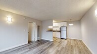 Located at 4325 Berryman Ave in the sought-after Mar Vista neighborhood of Los Angeles, this single-floor unit offers a clean, modern aesthetic with thoughtfully updated finishes throughout. The open-concept living and kitchen area is anchored by light-toned wood-style flooring that flows seamlessly through the space, complemented by soft neutral wall tones and a textured ceiling. Wall-mounted sconce lighting adds a warm, inviting ambiance to the living area.

The kitchen is efficiently designed with crisp white shaker cabinetry, dark countertops, a stainless steel sink with a modern gooseneck faucet, a stainless steel refrigerator, and a gas range with an overhead vent hood. A peninsula-style counter visually separates the kitchen from the living area while maintaining an open feel.

A dedicated hallway connects the living space to the private rooms, including a bedroom featuring a window with blinds and a wall-mounted air conditioning unit for personalized climate control. The bathroom is outfitted with a white vanity, dark countertop, a large mirror, and a tiled soaking tub and shower combination. A separate laundry area houses a stacked full-size washer and dryer unit alongside additional built-in cabinetry for storage, offering exceptional in-unit convenience.