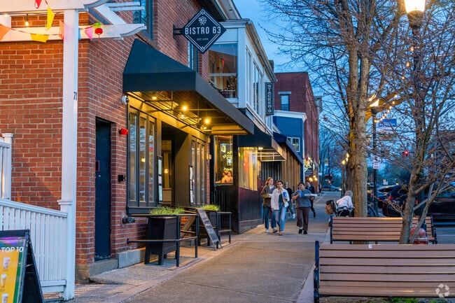People walk along Amherst's historic Main Street lined with shops and restaurants.