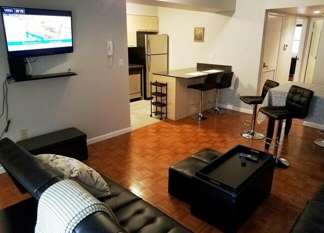 View of kitchen from living room. Notice the Roku TV (1 of 3 in the unit when rented as "Furnished") - 516 S 12th St