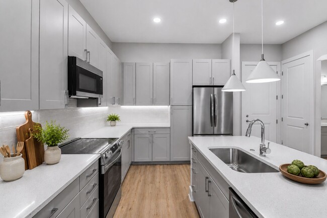 Quartz countertops, stainless steel appliances, and effortless style — this kitchen sets the tone for boundless living. - Brooking Square Apartments & Townhomes