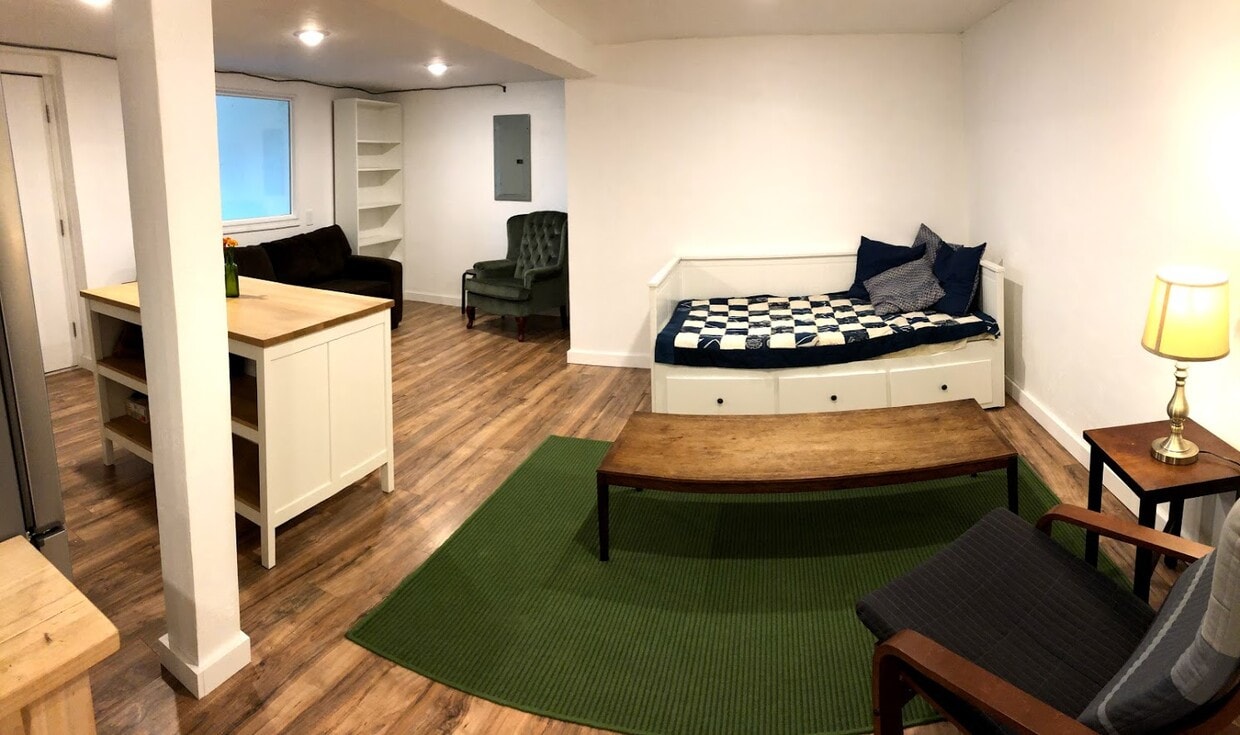 Large pantry closet near green chair with extra shelving installed for jars/containers. Furnishings not included. - 2415 E 12th St