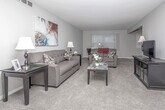 This well-appointed single-floor residence at 16176 Cumberland Dr in Southfield, Michigan offers a thoughtfully designed layout with a seamless flow between living, dining, and private spaces. The generously sized living room features plush carpeting, neutral-toned walls, and large windows with vertical blinds that allow abundant natural light to fill the space. The open connection to the dining area, which features light wood-look flooring, creates an inviting and functional layout ideal for both everyday living and entertaining. The kitchen is equipped with rich dark cabinetry, granite-style countertops, stainless steel appliances including a range, microwave, and dishwasher, and durable light-toned flooring. The bedrooms are carpeted and offer a calm, restful atmosphere, with windows providing natural light and ample room for furnishings. The primary bedroom is notably spacious, with a connecting hallway leading to a private bathroom. The bathrooms feature light vinyl flooring, dark vanity cabinetry, clean white fixtures, and well-lit mirrors. Throughout the residence, a consistent neutral color palette and cohesive design choices contribute to a clean, modern aesthetic that is both practical and comfortable.