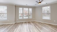 Located at 508 Pride Avenue in Herndon, VA, this three-story townhome offers three bedrooms, three bathrooms, and a well-organized layout across its floors. The entry level welcomes residents through a bold blue front door into a bright hallway with light wood-style flooring and direct access to the garage. Carpeted staircases connect all three levels with ease.

The main living floor serves as the heart of the home, featuring a spacious living room with crown molding, a ceiling fan, a fireplace, and multiple windows that invite generous natural light and neighborhood views. The adjacent kitchen is well-appointed with white shaker cabinets, quartz countertops, a subway tile backsplash, stainless steel appliances including a gas range, and a dedicated pantry. A combined dining area completes this central floor.

The upper level hosts all three bedrooms, including a primary suite with a walk-in closet equipped with wire shelving and an en-suite bathroom featuring both a soaking tub and a separate glass-door shower. Additional bedrooms offer light-filled interiors with wood-style flooring, ample closet space, and access to a shared bathroom. A dedicated laundry area and extra closets add to the home's practical storage throughout. The classic brick exterior and landscaped surroundings complete this well-appointed Herndon townhome.