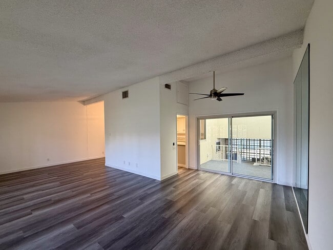 living room, dining room with new floors, vaulted ceilings, enclosed sun room & natural lighting - 3500 W Manchester Blvd