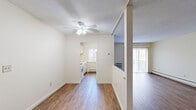 Located at 700 Metacom Ave in Bristol, Rhode Island, this one-bedroom, one-bathroom unit offers a well-organized single-floor layout designed for comfortable everyday living. Warm hardwood-style flooring runs throughout the main living areas, creating a cohesive and inviting atmosphere. The living room is generously sized, featuring a ceiling fan with light fixture, a textured ceiling, and sliding glass doors that open to a private balcony, allowing natural light to fill the space and providing outdoor views of the surrounding area. A wall-mounted air conditioning unit and baseboard heating ensure year-round comfort. The galley-style kitchen is efficiently laid out with white cabinetry, ample counter space, a gas range, dishwasher, and refrigerator, all complemented by a charming decorative window that brings in additional natural light. The spacious bedroom is carpeted for comfort, featuring a leaded-glass window, baseboard heating, and generous wall space. The full bathroom includes a vanity with storage, a toilet, and a tub-shower combination. A dedicated hallway with a closet rounds out the layout, offering practical storage. The unit's neutral color palette and clean finishes provide a versatile canvas throughout.