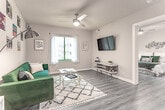 Located at 3200 W Broad St in Richmond, Virginia, this single-floor residence offers a thoughtfully designed layout with a cohesive, modern aesthetic throughout. The living room is a bright and open space, featuring wood-look flooring, a ceiling fan, and a large window that allows natural light to fill the room. The kitchen is a standout feature, equipped with stainless steel appliances including a refrigerator and range, white cabinetry, a subway tile backsplash, and a quartz-topped island with bar seating for two. Sleek pendant lighting anchors the kitchen space, which flows seamlessly into the rest of the unit. The bedroom is a serene retreat, finished with the same warm wood-look flooring, a ceiling fan, and a generous window that brings in natural light. Neutral walls and warm accent lighting create a calm and inviting atmosphere. The bathroom features tile flooring, a vanity with a stone countertop, and a shower-tub combination. Throughout the unit, clean white walls, consistent flooring, and modern finishes contribute to a cohesive and contemporary feel, making this a functional and stylish space in the heart of Richmond.