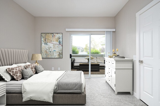 Experience serene living in this elegantly designed bedroom with access to a private patio. - Timberline Place Apartments
