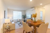 Located at 975 First St in Gilroy, CA, this well-designed 2-bedroom, 1-bathroom residence offers a thoughtfully organized single-level layout that maximizes every square foot. Light wood-style flooring flows throughout the home, lending a warm, cohesive feel to each room.

The open-concept living and dining area forms the heart of the home, bathed in natural light from large windows fitted with horizontal blinds. The living room offers a comfortable, airy atmosphere with recessed lighting and a wall-mounted mini-split climate control unit. The adjacent dining area provides ample space for a full dining table, while the connected kitchen is outfitted with crisp white cabinetry, white appliances including a dishwasher, electric range, microwave, and full-size refrigerator, along with light countertops and a stainless steel sink.

The primary bedroom is a serene retreat with its own mini-split unit, a closet, and direct views into the hallway. The second bedroom is bright and inviting, featuring a large window with natural light and a dedicated closet. The full bathroom is clean and modern, complete with a soaking tub and shower combination, a single-sink vanity, and a large mirror. Three closets throughout the home provide generous storage solutions.