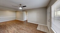 Located at 111 Edie Ann Dr in Lafayette, Louisiana, this 2-bedroom, 2-bathroom single-floor residence offers a practical and comfortable layout. Wood-style flooring runs throughout the main living areas, complemented by neutral gray walls and white trim that create a clean, cohesive aesthetic. The open living room is bright and welcoming, featuring a ceiling fan and a window that allows natural light to fill the space, with tile flooring at the entryway transitioning into the main floor.

The kitchen is well-appointed with warm cherry wood cabinetry, granite-style countertops, a double stainless steel sink, and white appliances including a range and refrigerator. A textured ceiling adds character throughout the home.

Both bedrooms are comfortably sized, each featuring wood-style flooring and ceiling fans for added comfort. Each bedroom is paired with its own closet — including a walk-in closet with wire shelving systems that maximize storage capacity.

The two bathrooms are finished consistently, showcasing cherry wood vanities topped with granite countertops, vessel-style sinks, and tub-shower combos with curved curtain rods. Wood-style flooring carries through these spaces as well, tying the home together with a unified, modern feel.