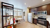 Located at 10878 Poblado Rd in San Diego, CA, this one-bedroom, one-bathroom residence offers a thoughtfully designed single-floor layout that maximizes every square foot. The open-concept living and dining area features light wood-tone flooring, vaulted ceilings with a ceiling fan, and a sliding glass door that opens to a private balcony, filling the space with natural light and providing a seamless indoor-outdoor connection.

The kitchen is a standout feature, showcasing rich dark-wood cabinetry with sleek hardware, light quartz countertops, and a full suite of stainless steel appliances including a refrigerator, range, microwave, and dishwasher. A dedicated in-unit laundry nook is conveniently tucked just off the kitchen area. The adjacent dining space accommodates a cozy bistro-style table, making it ideal for everyday meals.

The bedroom offers a comfortable and serene retreat, complete with plush carpeting, a ceiling fan, large windows with natural light, and a mirrored sliding closet. The full bathroom features a clean white tub/shower combination with brushed nickel fixtures. Neutral warm tones throughout create a cohesive and welcoming ambiance well-suited to the San Diego lifestyle.
