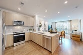 Located at 285 Mayson Ave NE in Atlanta's vibrant Inman Park neighborhood, this thoughtfully designed one-bedroom, one-bathroom residence offers a seamless blend of modern aesthetics and functional living. The open-concept layout unites the kitchen, dining, and living areas into one bright, cohesive space, anchored by warm wood-look flooring and recessed lighting throughout.

The contemporary kitchen is a standout feature, showcasing light wood flat-front cabinetry, a marble-style tile backsplash, white quartz countertops, and a peninsula island with a stainless steel sink and dishwasher. Stainless steel appliances complete the chef-ready setup. The kitchen flows effortlessly into the living and dining area, which is bathed in natural light from large windows and sliding glass doors opening to a private balcony.

The bedroom offers a comfortable retreat with dual windows, hardwood-style flooring, and a ceiling fan. A spacious walk-in closet with wire shelving provides ample storage. The bathroom impresses with large-format marble-look tile flooring, a tub-shower combination with matching tile surround, and a floating wood vanity with a white countertop. A dedicated laundry area adds everyday convenience to this well-appointed Atlanta residence.