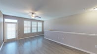 This single-floor residence offers three bedrooms and two bathrooms within a thoughtfully designed layout. The living area features neutral-toned walls, wood-look hard flooring, a ceiling fan, and bright windows with blinds that bring in ample natural light, creating an open and airy atmosphere.

The kitchen is a standout feature, equipped with dark espresso cabinetry, granite countertops, a subway tile backsplash, and a full suite of stainless steel appliances including a refrigerator with ice maker, electric range, built-in microwave, and dishwasher. A central island with additional granite counter space adds functionality, while pendant lighting and track lighting illuminate the workspace effectively. Light wood-look flooring runs throughout the kitchen.

All three bedrooms are carpeted and include ceiling fans. Each room offers comfortable proportions, neutral walls, and window access to natural light. At least one bedroom includes a generously sized walk-in closet with wire shelving systems for organized storage.

Both bathrooms feature soaking tub and shower combinations with white tile surrounds and brushed nickel fixtures. One bathroom includes wood-look tile flooring, while the other features tile flooring as well, both maintaining a clean, consistent aesthetic throughout the home.