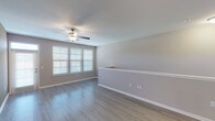 This single-floor residence offers three bedrooms and two bathrooms within a thoughtfully designed layout. The living area features neutral-toned walls, wood-look hard flooring, a ceiling fan, and bright windows with blinds that bring in ample natural light, creating an open and airy atmosphere.

The kitchen is a standout feature, equipped with dark espresso cabinetry, granite countertops, a subway tile backsplash, and a full suite of stainless steel appliances including a refrigerator with ice maker, electric range, built-in microwave, and dishwasher. A central island with additional granite counter space adds functionality, while pendant lighting and track lighting illuminate the workspace effectively. Light wood-look flooring runs throughout the kitchen.

All three bedrooms are carpeted and include ceiling fans. Each room offers comfortable proportions, neutral walls, and window access to natural light. At least one bedroom includes a generously sized walk-in closet with wire shelving systems for organized storage.

Both bathrooms feature soaking tub and shower combinations with white tile surrounds and brushed nickel fixtures. One bathroom includes wood-look tile flooring, while the other features tile flooring as well, both maintaining a clean, consistent aesthetic throughout the home.