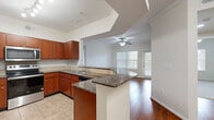 Located at 1760 Barker Cypress Rd in Houston, TX, this well-appointed 2-bedroom, 3-bathroom single-story home offers a thoughtfully designed layout with a welcoming entrance that opens into a flowing living area. Rich hardwood flooring runs throughout the main living spaces, complemented by crown molding and ceiling fans that add a polished finish to each room.

The kitchen is a standout feature, showcasing warm cherry wood cabinetry, dark granite countertops, a peninsula with breakfast bar seating, and a full suite of stainless steel appliances including a refrigerator, range, microwave, and dishwasher. Tile flooring grounds the kitchen, which opens seamlessly into the living room — a bright space with large windows and a ceiling fan that invites natural light throughout.

The primary bedroom is generously proportioned, featuring hardwood floors, crown molding, a ceiling fan, and direct outdoor access. It is supported by a dedicated walk-in closet with extensive wire shelving. The second bedroom offers plush carpet, a ceiling fan, and a large window. A second spacious walk-in closet provides ample additional storage. The bathrooms are finished with tile flooring and tub-shower combinations with full tile surrounds. The overall ambiance is clean, functional, and comfortable.