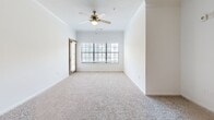Located at 3450 Miller Dr in Chamblee, GA, this well-appointed 2-bedroom, 3-bathroom residence offers a thoughtfully designed single-floor layout ideal for comfortable everyday living. The open-concept living and kitchen area serves as the heart of the home, featuring plush carpeting, crown molding, a ceiling fan, and generous natural light from large windows. A stylish breakfast bar with a pendant light creates a seamless transition into the kitchen, which is equipped with rich wood cabinetry, white quartz-style countertops, tile flooring, and stainless steel appliances including an over-the-range microwave and electric range. The spacious primary bedroom offers carpeted flooring, a ceiling fan, and ample room, while the second bedroom is equally well-sized with soft carpet and clean white walls. Both bedrooms are complemented by dedicated closets featuring wire shelving systems for organized storage. The three bathrooms are finished with tile flooring and include combinations of soaking tubs, separate shower enclosures, and wood-toned vanities. A dedicated laundry area houses a full-sized washer and dryer. The overall aesthetic is clean and neutral, creating a bright, move-in-ready environment throughout.