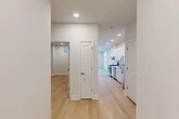 Located at 102 Hackett Blvd in Albany, NY, this well-appointed one-bedroom, one-bathroom residence offers a thoughtfully designed layout with modern finishes throughout. Light hardwood flooring flows seamlessly across the entire unit, creating a warm and cohesive aesthetic.

The galley-style kitchen is a standout feature, showcasing crisp white shaker cabinetry, striking marble-look quartz countertops and backsplash, and a full suite of stainless steel appliances including a gas range, dishwasher, and refrigerator. Recessed lighting illuminates the space efficiently.

A central hallway connects all rooms and includes two closets for ample storage. The spacious living area benefits from abundant natural light through charming arched windows and is equipped with a wall-mounted mini-split HVAC unit for year-round comfort. The bedroom is generously sized, featuring its own mini-split unit and a small window for ventilation and light.

The bathroom is finished in clean white tile, complete with a soaking tub and shower combination, a white vanity, and polished brushed-nickel fixtures. Throughout the unit, a neutral, bright color palette and recessed lighting contribute to a fresh, modern ambiance that is both functional and inviting.