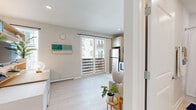 Located at 1116 W Carmen St in Tampa, FL, this efficiently designed studio offers a bright and modern single-floor layout that maximizes every square foot. Light-toned, wood-look tile flooring flows throughout the entire space, creating a seamless and airy aesthetic.

The open-concept living area is bathed in natural light from a large sliding glass door that opens to a private balcony with views of the surrounding neighborhood. The living space comfortably accommodates a seating area alongside built-in shelving, offering both functionality and style.

The kitchen is thoughtfully integrated into the main living area and features light wood cabinetry, open shelving, stainless steel appliances — including a refrigerator, electric range, and microwave — as well as a dedicated sink area with a modern faucet. Recessed lighting overhead adds to the clean, polished finish.

A well-defined entryway greets residents upon arrival, with a decorative mirror, closet access, and immediate sight lines to the bathroom. The bathroom is crisp and bright, finished in white subway tile and featuring a full soaking tub with shower, a modern vanity with wood-toned cabinetry, and ample storage.

The overall ambiance is fresh, minimal, and contemporary — ideal for those seeking a well-appointed space in a vibrant Tampa location.
