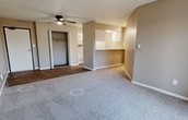 This 540 square foot apartment in West Des Moines, Iowa, offers a well-designed living space with two bedrooms and one bathroom. The open-concept layout maximizes the use of space, creating a seamless flow between the living and dining areas. The primary bedroom is notably spacious at 350 square feet, providing ample room for relaxation and storage.

The apartment features a mix of flooring materials, with plush carpeting in the bedrooms and living area, and durable wood-look flooring in the entryway and bathroom. Neutral-toned walls throughout create a bright, airy atmosphere and allow for personalized decor.

A ceiling fan in the main living area aids in air circulation, while large windows and a sliding glass door leading to a balcony invite natural light and offer outdoor views. The bathroom is efficiently designed with a combination tub-shower, modern fixtures, and a vanity for storage.

The kitchen, while not fully visible in the images, appears to be integrated into the main living space, contributing to the open feel of the apartment. A closet in one of the bedrooms provides additional storage options.

Overall, this apartment combines functionality with modern aesthetics, offering a comfortable living environment in a convenient West Des Moines location.