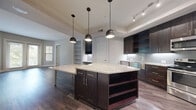 This contemporary residence at 1212 Singleton Blvd, Dallas, TX, offers 970 square feet of meticulously designed living space. The single-story floor plan comprises 2 bedrooms, including a spacious 150 sq ft primary suite, and 3 luxurious bathrooms. The heart of the home is an open-concept kitchen and living area, perfect for both entertaining and daily life. The gourmet kitchen boasts dark wood cabinetry, granite countertops, stainless steel appliances, and a stylish subway tile backsplash. Elegant wood-look flooring flows throughout the main living areas, while plush carpeting adds comfort to the bedrooms. Large windows and French doors invite ample natural light, creating a bright and airy atmosphere. The bathrooms feature modern fixtures, including glass-enclosed showers with designer tile work. Additional amenities include spacious closets and a dedicated laundry area. With its thoughtful design and high-end finishes, this home offers a perfect blend of style and functionality in a compact footprint.