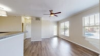 Located at 350 Whitewater Dr in Bolingbrook, IL, this 1-bedroom home spans two floors and offers a well-organized layout with comfortable living spaces throughout. The ground level provides access to a generously sized attached garage equipped with an automatic opener, offering ample storage and parking space. A staircase leads up to the main living floor, where the majority of the home's space is found. The open-concept kitchen and living room form the heart of the residence. The kitchen features warm honey-toned cabinetry, dark granite-style countertops, a stainless steel dishwasher, a range, and a double sink, with louvered pantry doors providing additional storage. The living room is bright and airy, with hardwood-style flooring, a ceiling fan, crown molding, and multiple windows that allow natural light to pour in. A white-mantled wood-burning fireplace serves as a focal point, adding warmth and character. A private entrance door opens to an outdoor view. The spacious primary bedroom is carpeted and features dual windows, a ceiling fan, and direct access to a walk-in closet fitted with wire shelving on multiple walls, offering excellent organization potential. Neutral tones throughout the home create a clean, move-in-ready aesthetic.