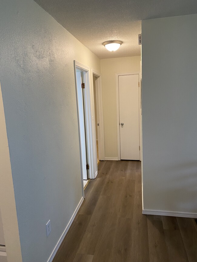 Hallway leading to two bedrooms and bathroom. - 1320 NE Minnehaha St