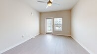 Located at 360 Orleans Ave in Santa Rosa Beach, FL, this well-appointed one-bedroom, one-bathroom residence offers a thoughtfully designed single-level floor plan with a clean, modern aesthetic throughout. Light-toned wood-style flooring runs continuously across all rooms, lending a cohesive and airy feel to the entire space.

The open-concept kitchen and living area serves as the heart of the home. The kitchen is equipped with stainless steel appliances—including a refrigerator with ice maker, electric range, built-in microwave, and dishwasher—complemented by crisp white cabinetry, a granite-topped island with pendant lighting overhead, and a ceiling fan in the adjoining living area. A door from the living space leads to an outdoor balcony, allowing for natural light and exterior views.

The bedroom is a generously sized, calm retreat with warm neutral walls, a ceiling fan, and a window with blinds. It connects to a dedicated closet with built-in shelving and rod storage, providing ample organization. The bathroom features a granite-topped vanity with white cabinetry, a large mirror, and a tub-shower combination with tiled surround. Recessed lighting and a clean, neutral palette give the entire residence a bright, move-in-ready character.