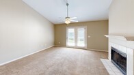 Located at 679 Michigan Ave in Foley, Alabama, this single-story 2-bedroom, 2-bathroom home offers a well-designed layout across a comfortable footprint. The living room serves as the heart of the home, anchored by a classic white-tiled fireplace with a painted mantel and flanked by vaulted ceilings that lend a sense of openness to the space. Warm neutral tones, plush carpeting, and a ceiling fan contribute to an inviting ambiance, while French doors provide natural light and direct access to a private outdoor deck.

The galley-style kitchen is efficiently laid out with white cabinetry, granite-look countertops, hardwood-style flooring, a skylight overhead, and black appliances including a refrigerator, electric range, microwave, and dishwasher. A pantry offers additional storage just off the kitchen.

The spacious primary bedroom features vaulted ceilings, a ceiling fan, a large closet, and a window with natural light. The second bedroom is equally comfortable with its own ceiling fan and closet. Both bathrooms are finished with white cabinetry, granite-look countertops, framed mirrors, and hardwood-style flooring, maintaining a cohesive and clean aesthetic throughout the home.