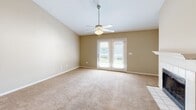 Located at 679 Michigan Ave in Foley, Alabama, this single-story 2-bedroom, 2-bathroom home offers a well-designed layout across a comfortable footprint. The living room serves as the heart of the home, anchored by a classic white-tiled fireplace with a painted mantel and flanked by vaulted ceilings that lend a sense of openness to the space. Warm neutral tones, plush carpeting, and a ceiling fan contribute to an inviting ambiance, while French doors provide natural light and direct access to a private outdoor deck.

The galley-style kitchen is efficiently laid out with white cabinetry, granite-look countertops, hardwood-style flooring, a skylight overhead, and black appliances including a refrigerator, electric range, microwave, and dishwasher. A pantry offers additional storage just off the kitchen.

The spacious primary bedroom features vaulted ceilings, a ceiling fan, a large closet, and a window with natural light. The second bedroom is equally comfortable with its own ceiling fan and closet. Both bathrooms are finished with white cabinetry, granite-look countertops, framed mirrors, and hardwood-style flooring, maintaining a cohesive and clean aesthetic throughout the home.