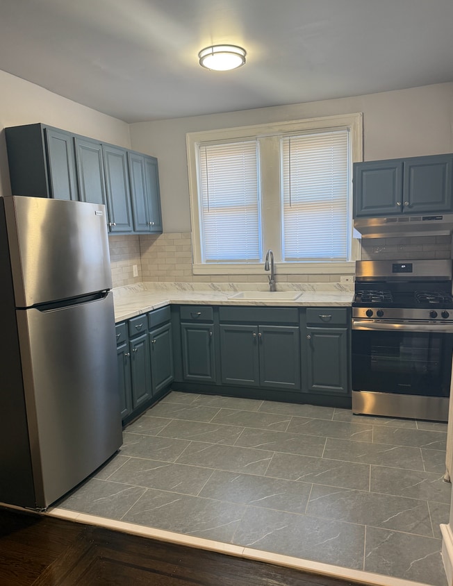 kitchen with stainless steal appliances - 6305 Kingsessing Ave